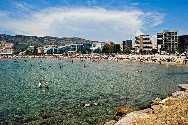 spanish coast Old men gabbling young man snorkelling in the sea at Orpesa