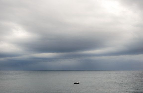 spanish coast A lonely boat in March near cadaques