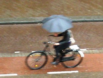 Dutch commuter cycling to work in rain