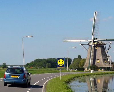 car driving by windmill with smile face